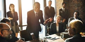 A businessman speaks to his team.