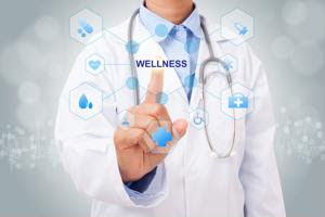 A doctor touches a diagram labeled "wellness."