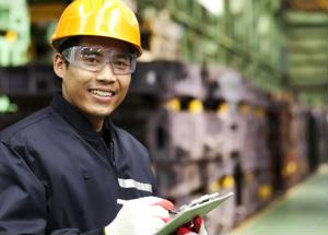 An employee wears PPE in a facility.